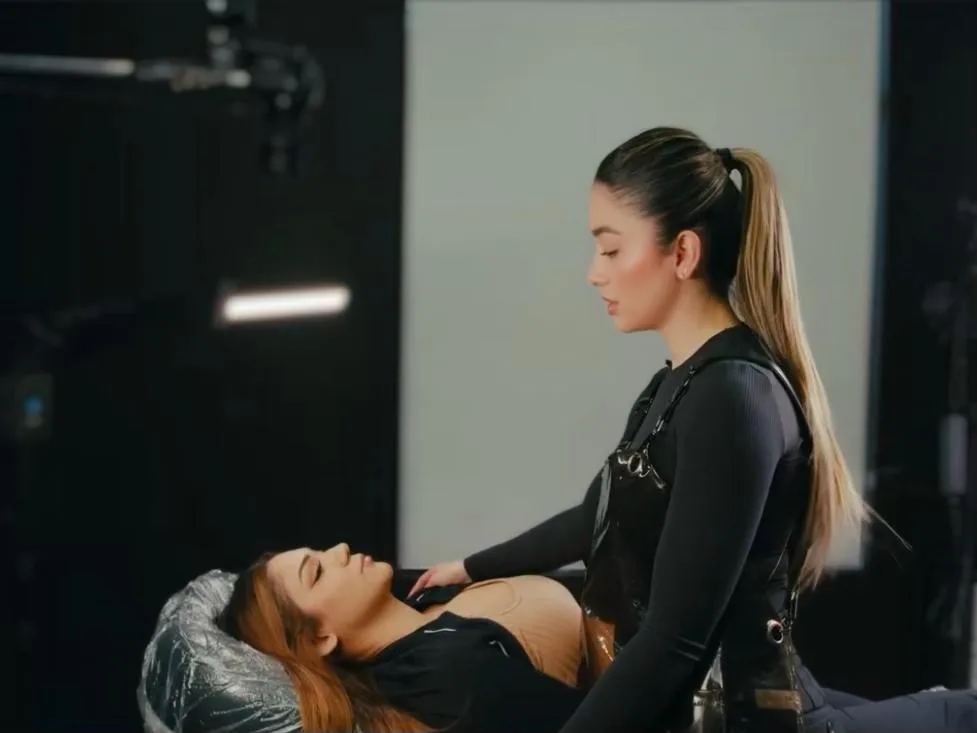 Permanent makeup artist demonstrating precise brow work