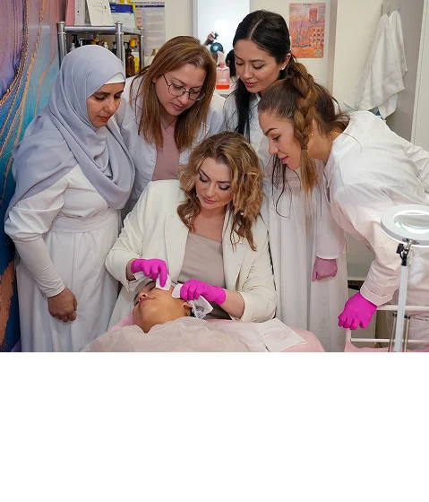 Mariia demonstrating a facial technique to esthetics students